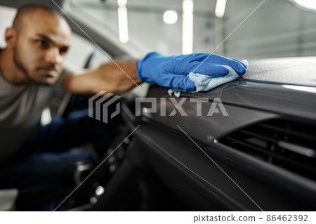 A man cleaning car interior, car detailing in Carwash service 86462392