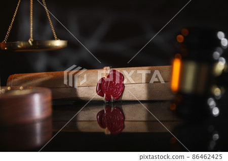 Document with wax seal, scales and antique stamp on a desk. Last will and legacy concept Document with wax seal, scales and antique stamp on a desk. Last will and legacy concept 86462425