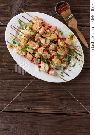 BBQ picnic with kebabs and meat on an open fire on a summer day in the backyard of a private house. 86463059