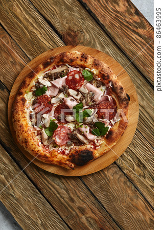 Meat Italian pizza with roast beef, steak slices, melted cheese, with olive slices and cheddar cheese. Close up, macro. Pizza time concept. Meat Italian pizza with roast beef, steak slices, melted cheese, with olive slices and cheddar cheese. Close up, macro. Pizza time concept. 86463995