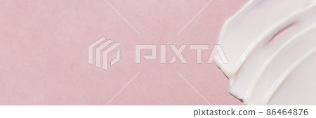 Smear of cosmetic cream on a pink background. 86464876