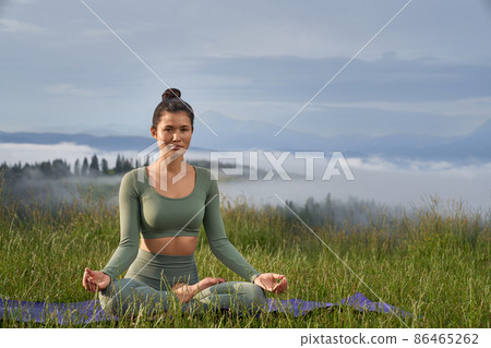 Beautiful woman in lotus pose. Beautiful woman in lotus pose. 86465262