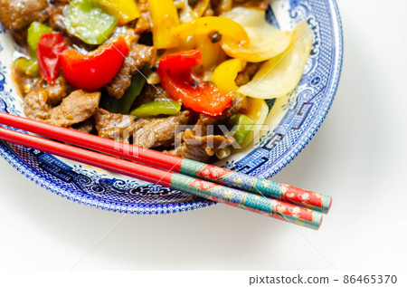 Cooked marinated beef slices with a savory black beef sauce, peppers and onions Cooked marinated beef slices with a savory black beef sauce, peppers and onions 86465370