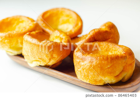 Traditional English Yorkshire pudding, wonderfully crisp and golden baked for a traditional recipe, accompaniment for the perfect Sunday roast Traditional English Yorkshire pudding, wonderfully crisp and golden baked for a traditional recipe, accompaniment for the perfect Sunday roast 86465403