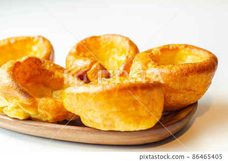 Traditional English Yorkshire pudding, wonderfully crisp and golden baked for a traditional recipe, accompaniment for the perfect Sunday roast Traditional English Yorkshire pudding, wonderfully crisp and golden baked for a traditional recipe, accompaniment for the perfect Sunday roast 86465405