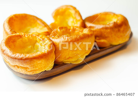 Traditional English Yorkshire pudding, wonderfully crisp and golden baked for a traditional recipe, accompaniment for the perfect Sunday roast 86465407