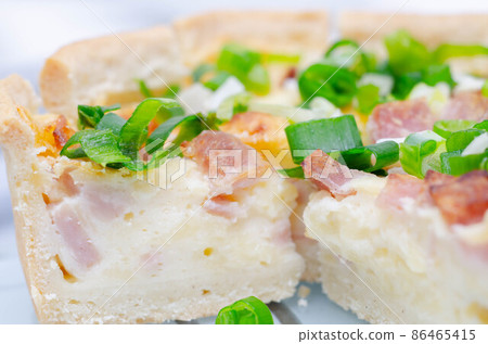 Quiche Lorraine, smoked bacon with medium  and mature cheddar cheese and egg quiche filling in a shortcrust pastry 86465415