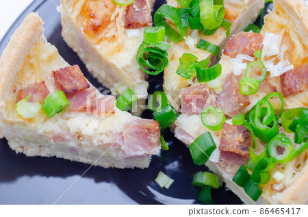 Quiche Lorraine, smoked bacon with medium  and mature cheddar cheese and egg quiche filling in a shortcrust pastry 86465417