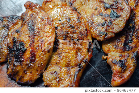Fresh and juicy pork loin steaks, grilled meats on the wooden board Fresh and juicy pork loin steaks, grilled meats on the wooden board 86465477