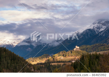 Tarasp castle lights up in evening light Tarasp castle lights up in evening light 86465992