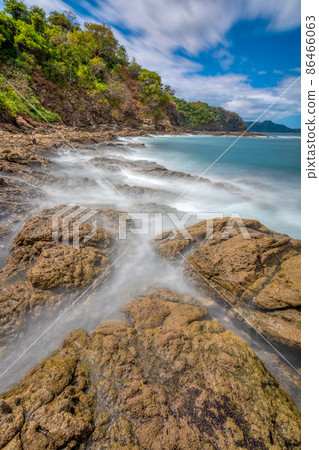 Long exposure, pacific ocean waves on rock in Playa Ocotal, El Coco Costa Rica Long exposure, pacific ocean waves on rock in Playa Ocotal, El Coco Costa Rica 86466063