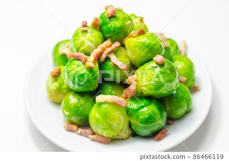 Tasty brussels sprouts with smoked bacon lardons and salted butter 86466119