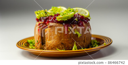 Seasoned British pork, wrapped in crisp, flavoursome pastry served with  beetroot and orange chutney on top 86466742