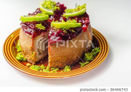 Seasoned British pork, wrapped in crisp, flavoursome pastry served with  beetroot and orange chutney on top 86466743