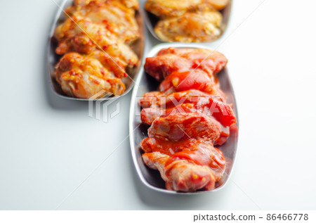 Three different set of the chicken wings with sriracha glaze, Caribbean marinade and Chinese glaze Three different set of the chicken wings with sriracha glaze, Caribbean marinade and Chinese glaze 86466778