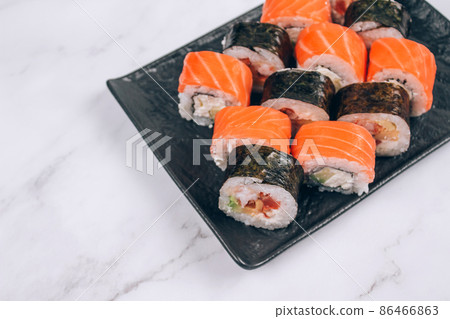 Sushi bar lunch menu, different sushi rolls with salmon, avocado and smocked eel on white marble table background. Online order delivery food online, takeout food concept Sushi bar lunch menu, different sushi rolls with salmon, avocado and smocked eel on white marble table background. Online order delivery food online, takeout food concept 86466863