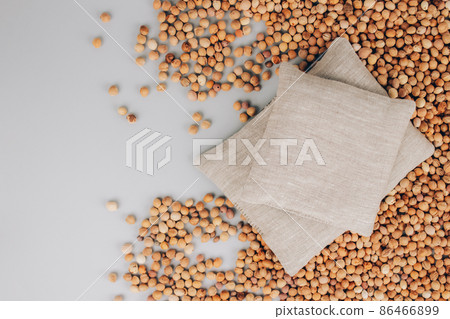 Set of two cherry pits heating pads. Cherry stone pillow on cherry stones background with copy space. Natural heat or cool pack. Alternative medicine and therapy, pit sack for spa massage 86466899