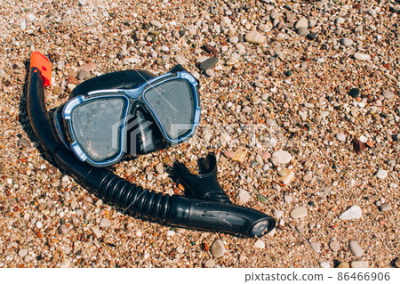 Diving concept, underwater dive mask on sea shore Diving concept, underwater dive mask on sea shore 86466906