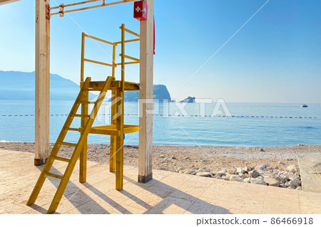 Rescue station on the sea beach. Rescue cabin on the coastline in sunny day, beach without people 86466918
