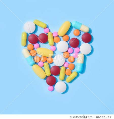 Cardiovascular deseases. Immune system vitamins and supplemets. Dietary bio supplements on blue background with copy space. Assorted multicolored medicine pills, capsules and tablets Cardiovascular deseases. Immune system vitamins and supplemets. Dietary bio supplements on blue background with copy space. Assorted multicolored medicine pills, capsules and tablets 86466935