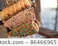Fresh cooked traditional Czech trdlo or trdelnik, at street food market stall. National street food in Czech Republic and Hungary. Hungarian kurtoskalacs 86466965