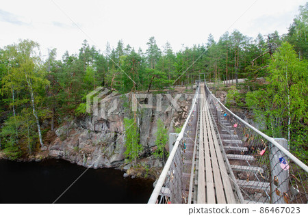 Rope bridge in the National Park Repovesi, Finland. 86467023