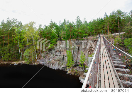 Rope bridge in the National Park Repovesi, Finland. Rope bridge in the National Park Repovesi, Finland. 86467024
