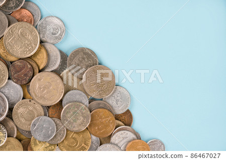 Variety of old coins on light blue background with copy space. Various vintage coins from worldwide as background. Financial growth and business concept. Numismatics and coin collecting Variety of old coins on light blue background with copy space. Various vintage coins from worldwide as background. Financial growth and business concept. Numismatics and coin collecting 86467027