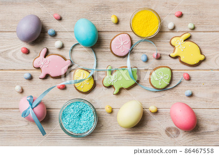 holiday preparation Multi colors Easter eggs with cookies on colored background . Pastel color Easter eggs. holiday concept with copy space holiday preparation Multi colors Easter eggs with cookies on colored background . Pastel color Easter eggs. holiday concept with copy space 86467558