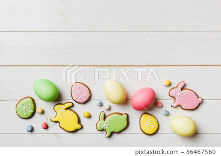 holiday preparation Multi colors Easter eggs with cookies on colored background . Pastel color Easter eggs. holiday concept with copy space 86467560
