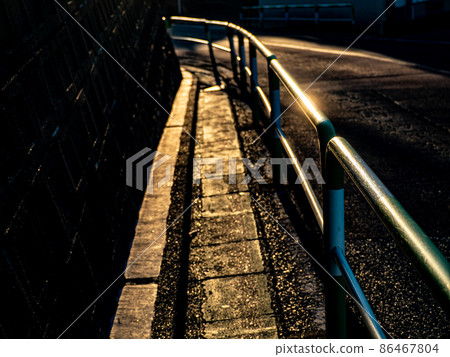 Guardrail on the school road where the morning sun is dazzling Guardrail on the school road where the morning sun is dazzling 86467804