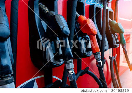 Gas pump nozzle in petrol station. Fuel nozzle in oil dispenser. Fuel dispenser machine. Refueling fill up with petrol gasoline and diesel. Petrol industry and service. Petroleum oil consumption. 86468219