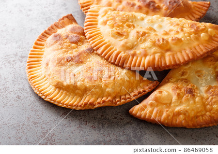Chebureki are savory turnovers that are the definition of Slavic comfort food close up. Horizontal Chebureki are savory turnovers that are the definition of Slavic comfort food close up. Horizontal 86469058