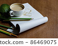 Cup of coffee latte in a cafe on a notepad on a wooden table 86469075