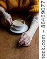 Woman in a cafe drinking coffee. Soft focus 86469077