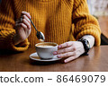 Woman in a cafe drinking coffee 86469079