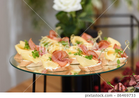 bruschetta with prosciutto ham and figs with cheese. fresh basil. italian appetizer. bruschetta with prosciutto ham and figs with cheese. fresh basil. italian appetizer. 86469733