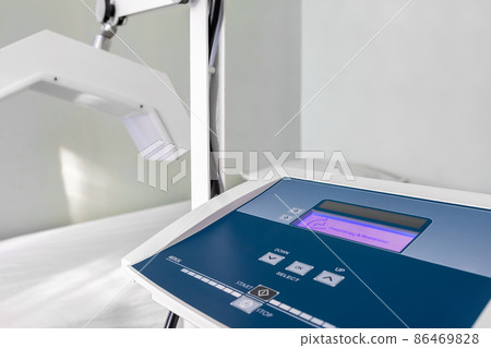 Close-up detail view of physiotherapy medical diathermy treatment equipment. Microwave therapy room with couch. Physical rehabilitation service device at hospital. Healthcare modern technologies Close-up detail view of physiotherapy medical diathermy treatment equipment. Microwave therapy room with couch. Physical rehabilitation service device at hospital. Healthcare modern technologies 86469828