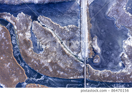 Aerial view from a drone on a frozen rural landcape 86470156