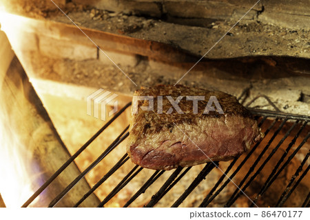 Beautiful piece of beef fillet on a coal grill 86470177