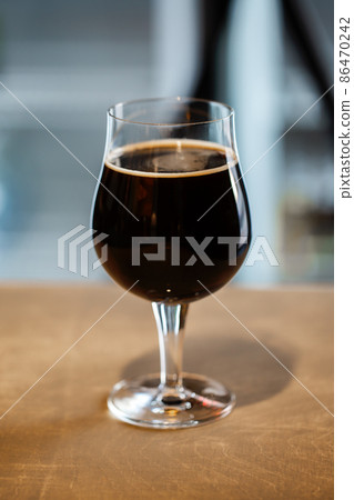 Snifter glass of russian imperial stout craft beer on wooden surface Snifter glass of russian imperial stout craft beer on wooden surface 86470242