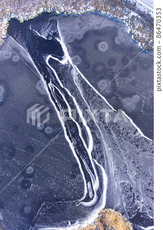 Aerial view on a frozen pond covered in ice Aerial view on a frozen pond covered in ice 86470353