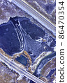 Aerial view on a frozen lake between countryside road highway in winter 86470354