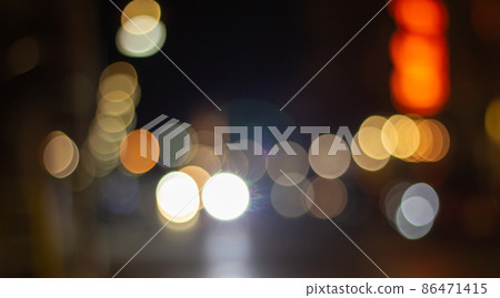 Out of focus defocused blurred bokeh of cars and traffic lights at night on city street. Out of focus defocused blurred bokeh of cars and traffic lights at night on city street. 86471415