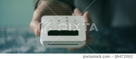 man with a payment terminal in his hand web banner 86472002