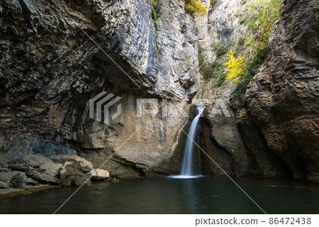 The Momin Skok waterfall near Emen in Bulgaria - autumn landscape 86472438
