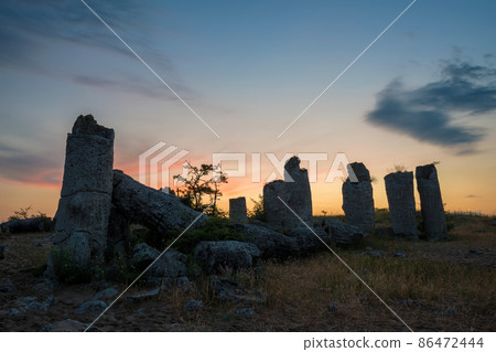 Beautyful sunrise over The Stone Desert Pobiti Kamani - fabulous rock phenomenon in Varna Province, Bulgaria - tourist destination 86472444