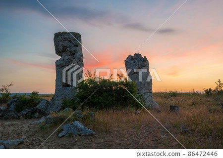 Beautyful sunrise over The Stone Desert Pobiti Kamani - fabulous rock phenomenon in Varna Province, Bulgaria - tourist destination Beautyful sunrise over The Stone Desert Pobiti Kamani - fabulous rock phenomenon in Varna Province, Bulgaria - tourist destination 86472446