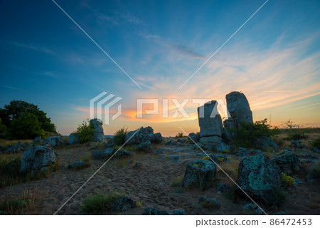 Beautyful sunrise over The Stone Desert Pobiti Kamani - fabulous rock phenomenon in Varna Province, Bulgaria - tourist destination 86472453