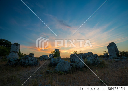 Beautyful sunrise over The Stone Desert Pobiti Kamani - fabulous rock phenomenon in Varna Province, Bulgaria - tourist destination 86472454